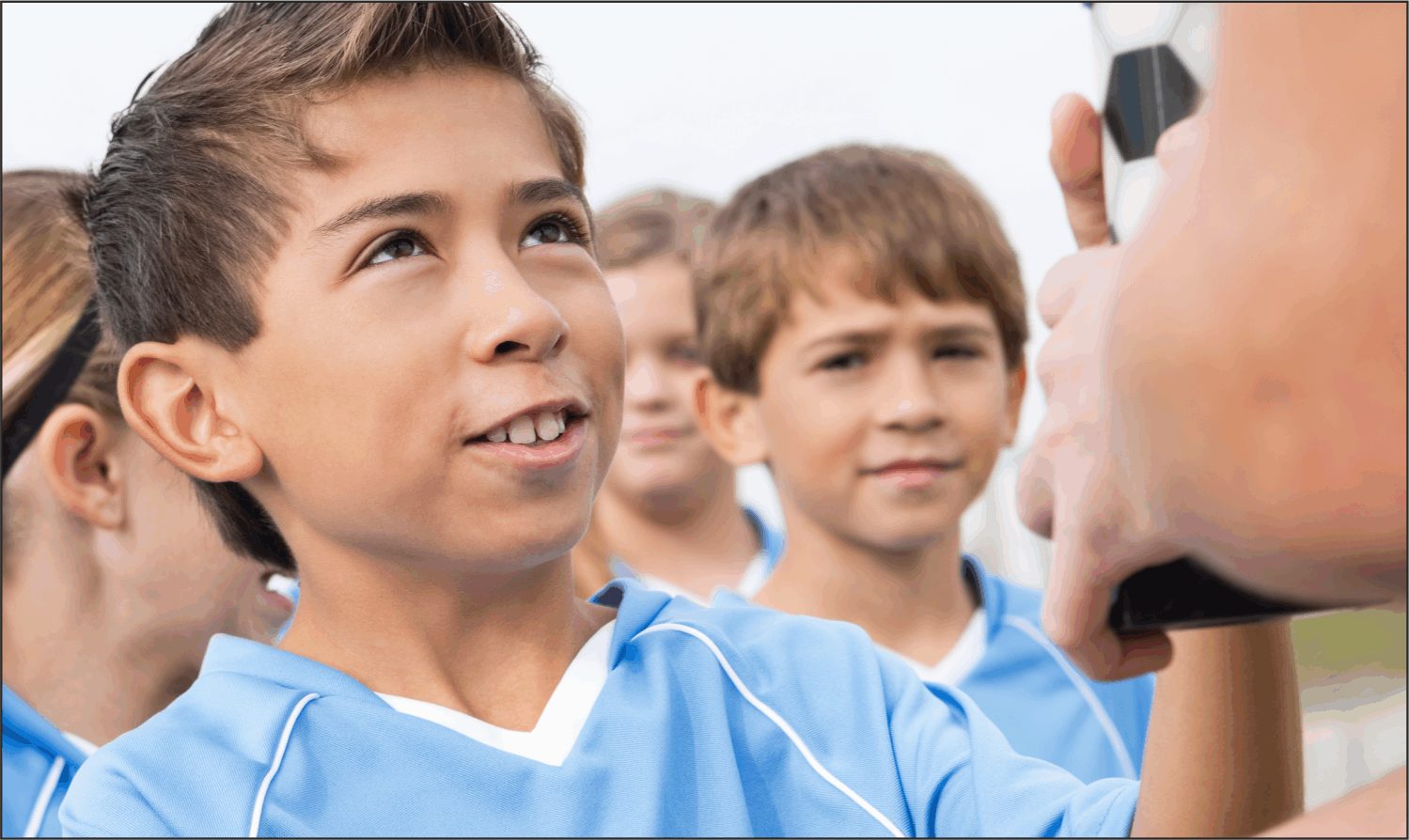 Young players listening to their coach